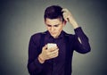 Funny clueless dumb guy having troubles with his smartphone Royalty Free Stock Photo