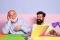 Funny colleagues having fun sitting at desk with laptops. Excited business man in office with colleagues. Funny office Royalty Free Stock Photo