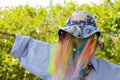 Funny colorful rainbow mesh scarecrow with pale blue shirt Royalty Free Stock Photo