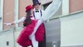 Funny comic couple on stilts dancind cool