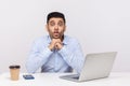 Funny comical amazed man employee sitting office workplace with laptop, making humorous fish face with big eyes Royalty Free Stock Photo