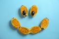 Funny composition with halves of ripe cactus pears on color background