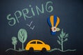 Funny composition on the theme of spring in a cartoon style, car , forest and a balloon