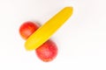 Funny concept of fruit, banana and two red oranges isolated on white background Royalty Free Stock Photo