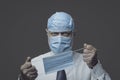 Funny businessman wearing many surgical masks