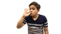 Funny and confident face expression of young Asian Malay man with strips t-shirt showing okay sign and kiss finger Royalty Free Stock Photo