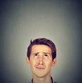 Funny confused skeptical man thinking looking up Royalty Free Stock Photo