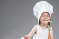 Portrait of Smiling Little Caucasian Girl in Cook Uniform Posing with Whisk Royalty Free Stock Photo