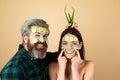 Funny couple with cucumbers mask on face. Girl with facial skincare fresh clean skin and beauty concept.