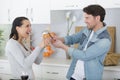Funny couple fight with utensils tools Royalty Free Stock Photo