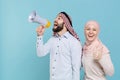 Funny couple friends arabian muslim man wonam in keffiyeh kafiya ring igal agal hijab clothes isolated on blue