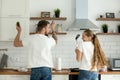 Funny couple having fun cooking in kitchen together, rear view Royalty Free Stock Photo