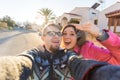 Funny couple With Keys Standing Outside New Home. Real estate, owner and people concept Royalty Free Stock Photo