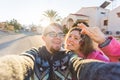 Funny couple With Keys Standing Outside New Home. Real estate, owner and people concept