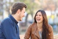 Funny couple laughing in the street