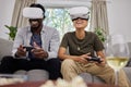 Funny couple, vr and gaming on sofa in home living room, happy and laughing together. Virtual reality, couch and African