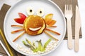 Funny crab face shape snack from pancake,apples,banana,kiwi on plate. Cute kids childrens baby's sweet dessert Royalty Free Stock Photo