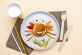 Funny crab face shape snack from pancake,apples,banana,kiwi on plate. Cute kids childrens baby`s sweet dessert with milk, healthy Royalty Free Stock Photo