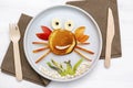 Funny crab face shape snack from pancake,apples,banana,kiwi on plate. Cute kids childrens baby's sweet dessert with Royalty Free Stock Photo