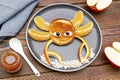 Funny crab face shape snack from pancake, orange,apples,honey on plate. Cute kids childrens baby's sweet dessert Royalty Free Stock Photo