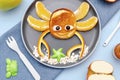 Funny crab face shape snack from pancake, orange,apples,honey on plate. Cute kids childrens baby\'s sweet dessert, healthy Royalty Free Stock Photo