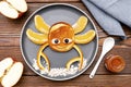 Funny crab face shape snack from pancake, orange,apples,honey on plate. Cute kids childrens baby's sweet dessert Royalty Free Stock Photo