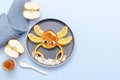 Funny crab face shape snack from pancake, orange,apples,honey on plate. Cute kids childrens baby's sweet dessert Royalty Free Stock Photo