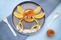 Funny crab face shape snack from pancake, orange,honey on plate. Cute kids childrens baby`s sweet dessert, healthy breakfast,lunc Royalty Free Stock Photo