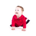 Funny crawling baby girl in a red dress Royalty Free Stock Photo