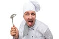 Funny crazy chef with a ladle shows tongue on a white Royalty Free Stock Photo