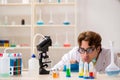 The funny crazy chemist doing experiments and tests Royalty Free Stock Photo