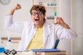 The funny crazy chemist doing experiments and tests Royalty Free Stock Photo