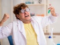 Funny crazy chemist doing experiments and tests Royalty Free Stock Photo