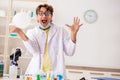 The funny crazy chemist doing experiments and tests Royalty Free Stock Photo