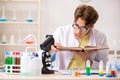 The funny crazy chemist doing experiments and tests Royalty Free Stock Photo