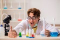 The funny crazy chemist doing experiments and tests Royalty Free Stock Photo