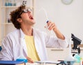 Funny crazy chemist doing experiments and tests Royalty Free Stock Photo