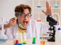 Funny crazy chemist doing experiments and tests Royalty Free Stock Photo