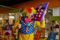 Funny crazy clown talking huge toy phone while entertaining at playroom