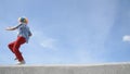 Crazy mime dance on the parapet with a tambourine against the sky. Funny clown antics