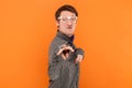 Funny crazy disabled man nerd pointing and looking at camera with clenched teeth, wearing shirt. Royalty Free Stock Photo