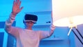 Funny crazy granny. Elderly woman wearing VR goggles