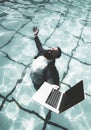 Funny and crazy man Freelancer in suit using a computer in swimming Pool. Funny Freelanc. Working on laptop from the Royalty Free Stock Photo
