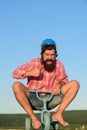 Funny crazy man riding a bike. Nerdy hipster guy riding a small bicycle. Royalty Free Stock Photo