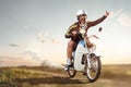 Funny crazy man riding on a vintage moped with his dog Royalty Free Stock Photo