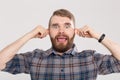 Funny crazy playful handsome man in plaid shirt making silly monkey face bulging ears showing tongue. Guy having fun Royalty Free Stock Photo