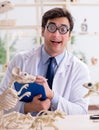 Funny crazy professor studying animal skeletons Royalty Free Stock Photo
