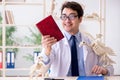 The funny crazy professor studying animal skeletons Royalty Free Stock Photo