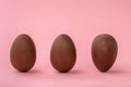 funny creative concept of Easter eggs on pink background