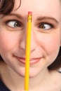 Funny cross eyes of woman with pencil on her nose